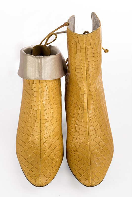 Mustard yellow women's ankle boots with laces at the back. Round toe. High block heels. Worn view - Florence KOOIJMAN